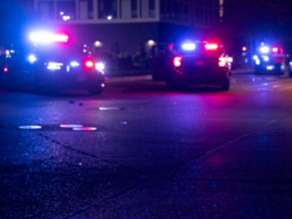 Abstracted night time view of police units repsonding to an emergency.