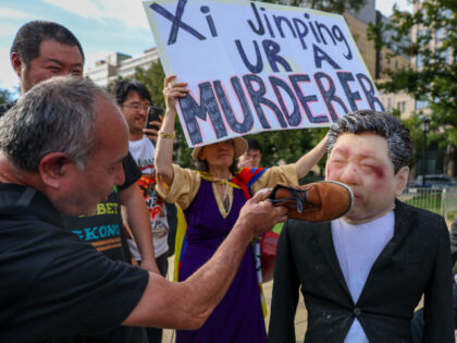 Protesters simulate assailing an effigy of President Xi near the White House on September