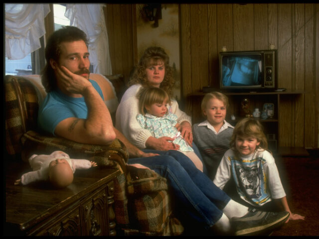 Working Class Family Minimum wage worker Al Wells w. wife Cindy & 3 children in the living room of their tr