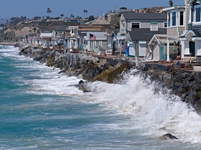 San Clemente, Calif. Sept. 15, 2026: High tide washes up on the boulders as crews work to