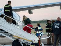 A woman in shackles boards the first deportation flight of undocumented Venezuelans after a US-Venezuelan agreement in Harlingen, Texas, on October 18, 2023. The United States said on October 5, 2023 it will resume deportation flights to Venezuela after a deal with Caracas, as President Joe Biden, seeking reelection, comes under pressure to halt border crossings. Washington has for years halted sending migrants back to Venezuela due to instability in the South American nation and still maintains sanctions against the government of President Nicolas Maduro. (Photo by VERONICA G. CARDENAS / AFP) (Photo by VERONICA G. CARDENAS/AFP via Getty Images)