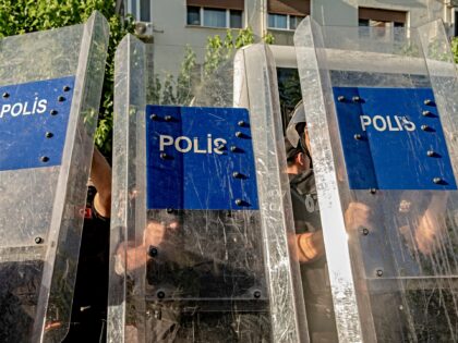 Police officers hold up riot shields in Izmir, Turkey, on June 27, 2026. Police intervened