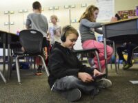 kids in classroom working on ipads
