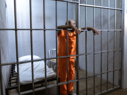 man in prison cell