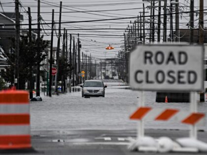 A van is seen stuck half-submerged in flood waters during the second day of a rare Septemb