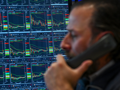 A trader works on the floor of the New York Stock Exchange (NYSE) at the opening bell on A
