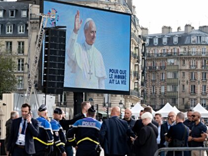 Officials from the French Ministry of the Interior and National Police officers conduct a