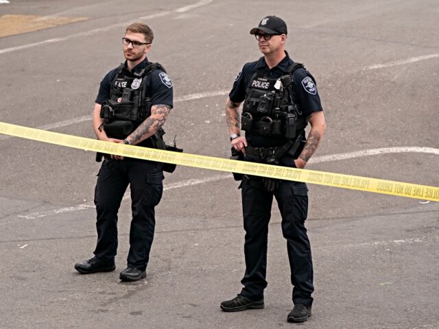 seattle police SEATTLE, WASHINGTON - JULY 26: Police officers keep watch after a mass shooting at the Bit