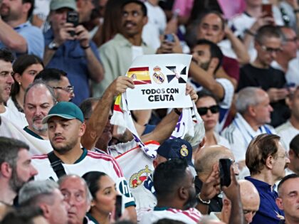 A supporter raises a banner reading "Everyone with Ceuta" before the UEFA Champions League