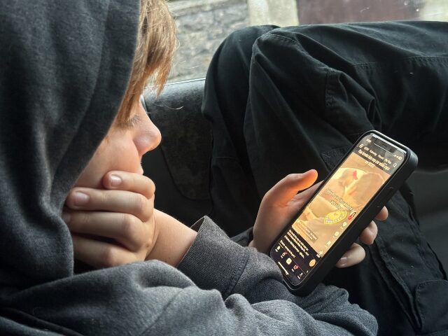 PORTSMOUTH, UNITED KINGDOM - OCTOBER 20: A 12-year-old boy looks at a iPhone screen on Oct