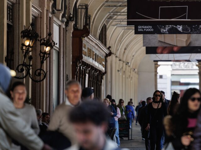 Pedestrians pass stores in a shopping street in Turin, Italy, on Friday, April 4, 2025. Ba