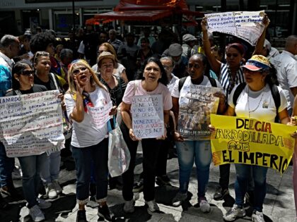 Demonstrators shout slogans during a protest against Venezuela's interim President Delcy R