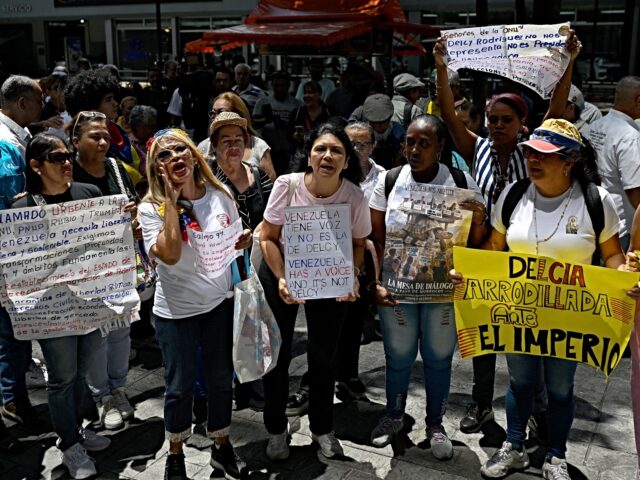 Demonstrators shout slogans during a protest against Venezuela's interim President Delcy R