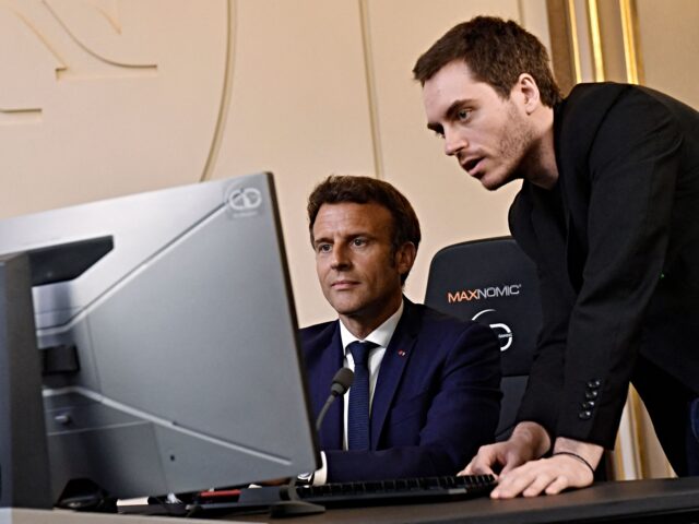 video games rench President Emmanuel Macron (C) plays a video game next to Adrien Nougaret, aka Zerato