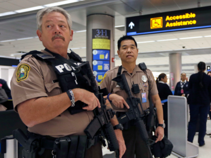 Miami-Dade police officers Dan Causey, left, and Jose Lam, right, guard the terminal at Mi