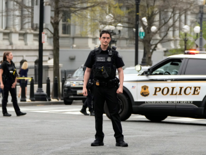 Members of the United States Secret Service monitor the scene near the the Eisenhower Exec