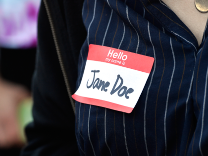 An attendee wears a name tag reading "Jane Doe" during a protest against Cornell