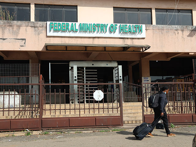 Title: Africa Ebola Image ID: 26294382070249 Article: A woman walks past the Federal Ministry of Health in Abuja, Nigeria, Wednesday, Oct. 21, 2026. (AP Photo/Afolabi Sotunde)