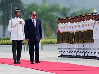 Egypt's President Abdel Fattah al-Sisi inspects a guard of honour during a state welcoming