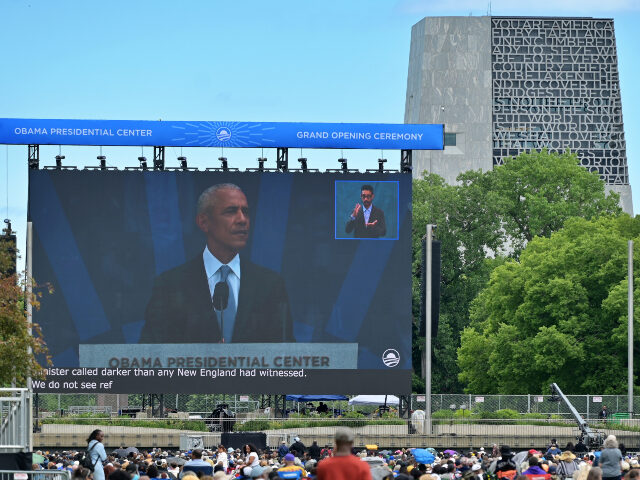 Barack Obama at presidential center A large screen displays Barack Obama at the Grand Opening Ceremony of the Obama Presidenti