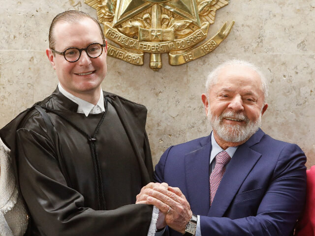 Cristiano Zanin and Lula Brazilian President Luiz Inacio Lula da Silva (R() shakes hands with the new Minister of t