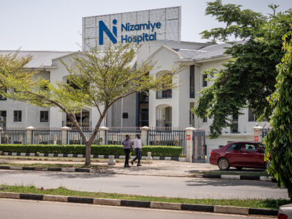 People walk past the Nizamiye Hospital in Abuja, on October 21, 2026, following a confirme