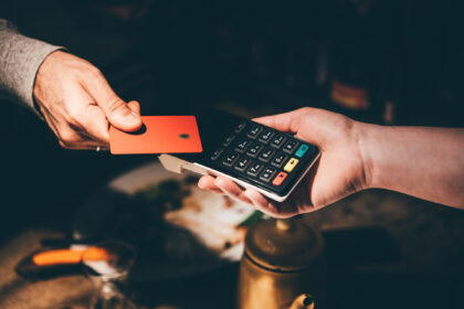 Man pays with a card in a cafe.