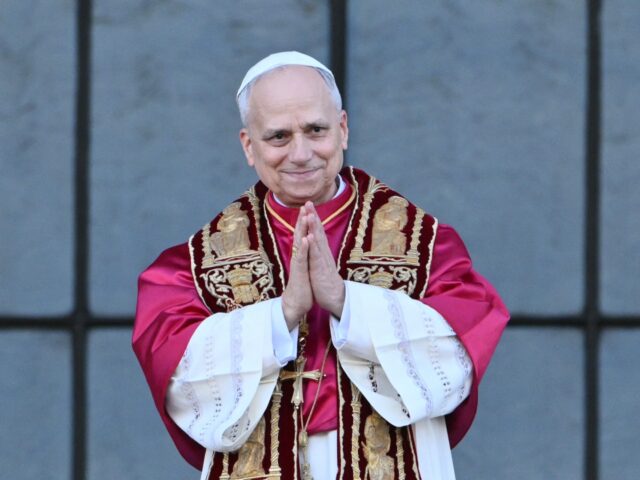 TOPSHOT - Pope Leo XIV greets the crowd from the main central balcony of Saint John Latera