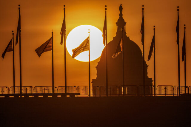WASHINGTON, DC - SEPTEMBER 16: The U.S. flag is silhouetted in the rising sun with the U.S