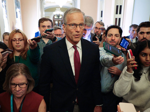 GettyImages-2297606193_ WASHINGTON, DC - SEPTEMBER 28: Senate Majority Leader John Thune (R-SD) talks with a clust