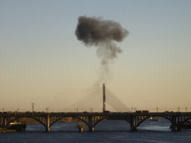 Smoke rises over a bridge spanning the Dnieper River following a drone attack in Kyiv on O