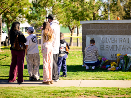 BEND, OREGON - OCTOBER 16: Community members grieve and lay flowers at the site of a makes
