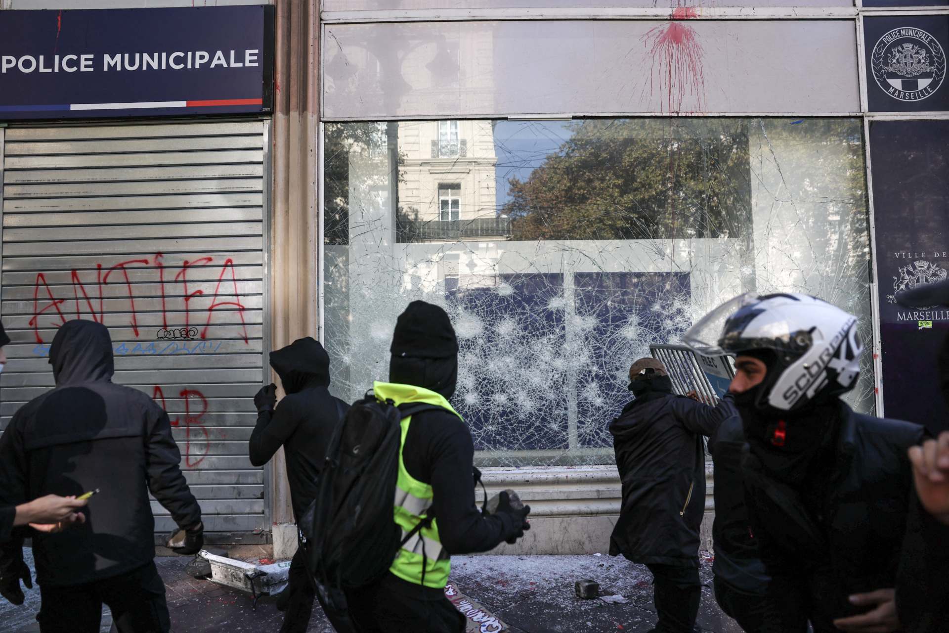Protesters vandalise a municipal police station prior to the start of a demonstration to protest against the "high cost of living", in Marseille, southern France, on October 17, 2026 as part of a nationwide call for mobilisation bringing together various groups expressing their anger: former "Yellow Vests", secondary school and university students, climate activists and even farmers. After weeks of student protests, France faces broader, nationwide demonstrations on October 17, 2026 over the cost of living, setting up a potentially fraught six months heading into a presidential election. A police source told AFP that authorities estimated nearly 200,000 people could take part, with 40,000 in Paris. (Photo by Thibaud MORITZ / AFP via Getty Images)