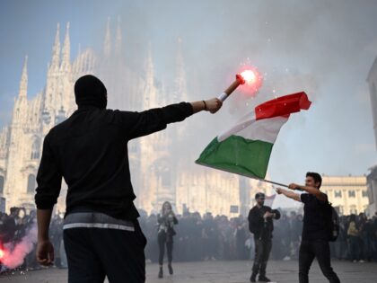 TOPSHOT - Demonstrators light flares during an anti-government protest organized by the It