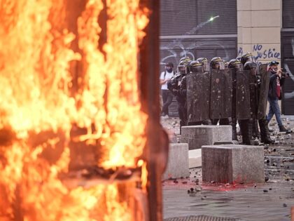 Protesters clash with French riot police during a demonstration against government policie