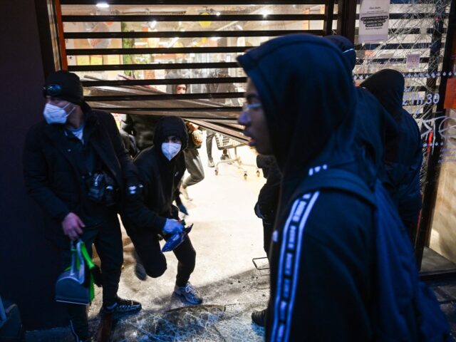 TOPSHOT - People enter a ransacked Franprix store as clashes erupted at Place de la Republ