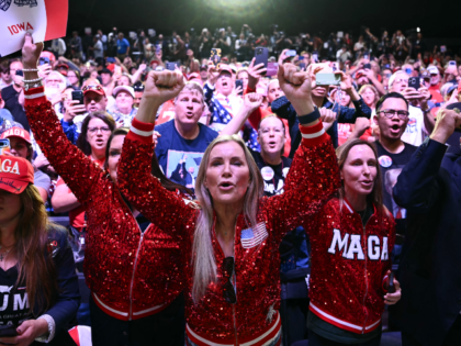 TOPSHOT - Supporters cheer as US President Donald Trump arrives to speak at a midterm elec