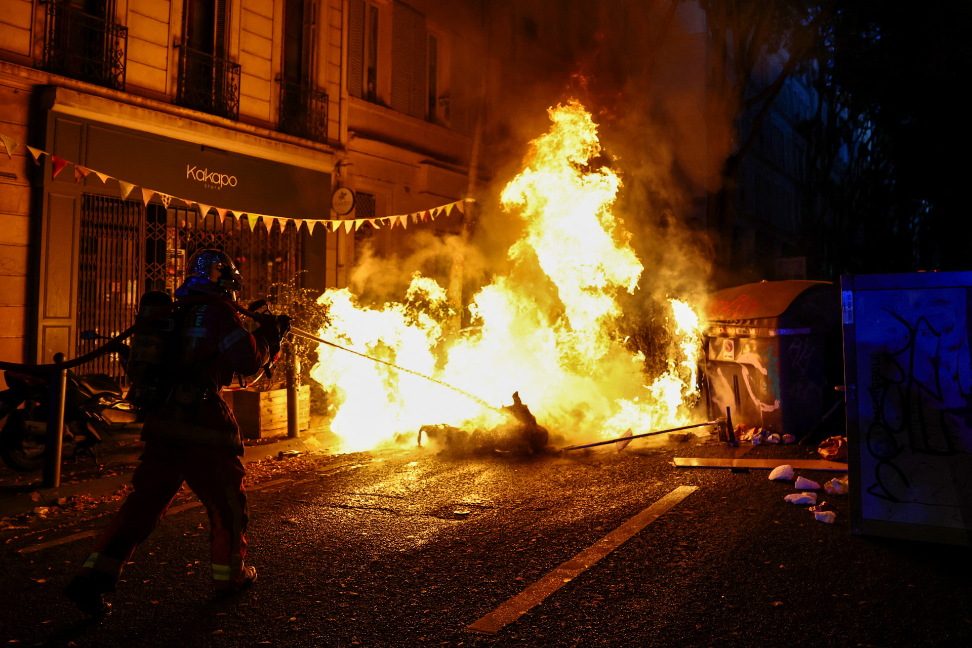 A french Pompier fireman extinguishes a burning barricade during a demonstration in favor of purchasing power, the protection of public services, and fiscal and social justice, in Marseille, southeastern France on October 24, 2026 as part of a nationwide call for mobilisation bringing together former members of the Yellow Vest movement, labor unions, high school and university students. Protests by high school students over learning conditions sparked a movement that has since spread nationwide, fuelled by broader anger over the rising cost of living. About 70,000 security personnel will be deployed on October 24, 2026, Interior Minister said at a news conference, warning that calls for violence and looting were circulating on social media. (Photo by Thibaud MORITZ / AFP via Getty Images)
