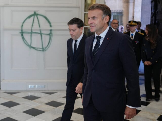 France's President Emmanuel Macron (R) and the mayor of Marseille Benoit Payan, walk past