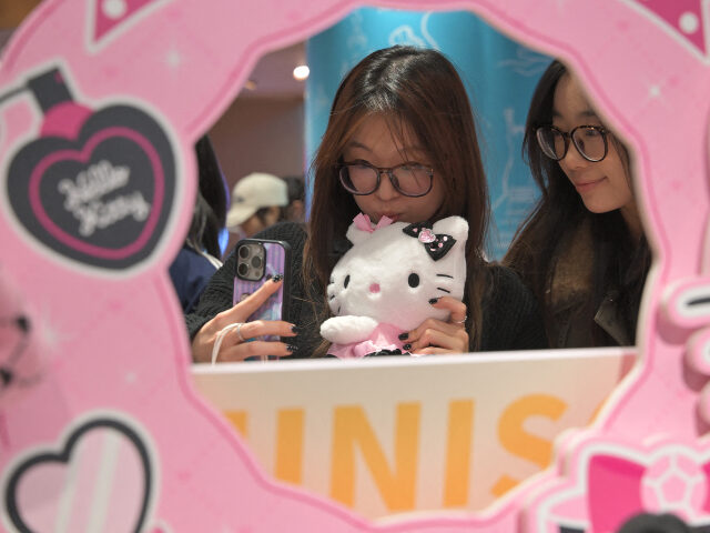 Girls have a selfie photo with products of character Hello Kitty created by Japanese compa