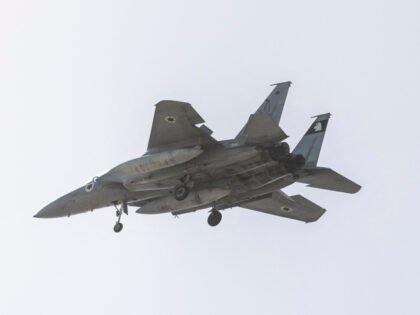 An Israeli Air Force F-15 fighter jet flies over the outskirts of Tel Aviv on March 20, 20