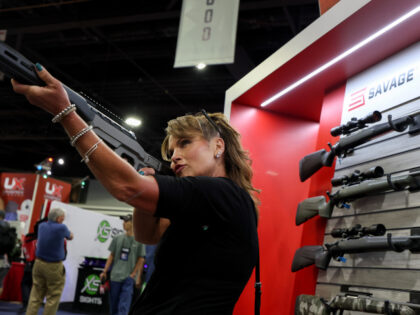 Andrea Foeste holds a Savage Arms rifle at the NRA the 2025 NRA Annual Meetings & Exhi