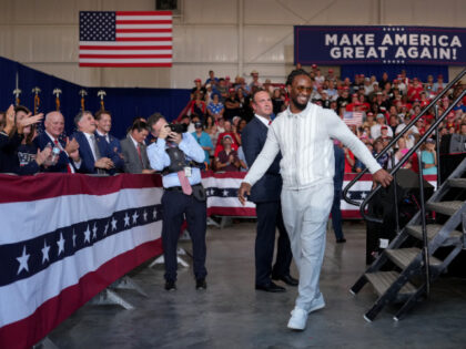 Former NFL running back Todd Gurley walks off stage after speaking at a campaign rally wit