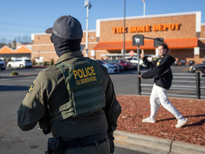 A U.S. Border Patrol agent stands outside a Home Depot store on November 19, 2025, in Char
