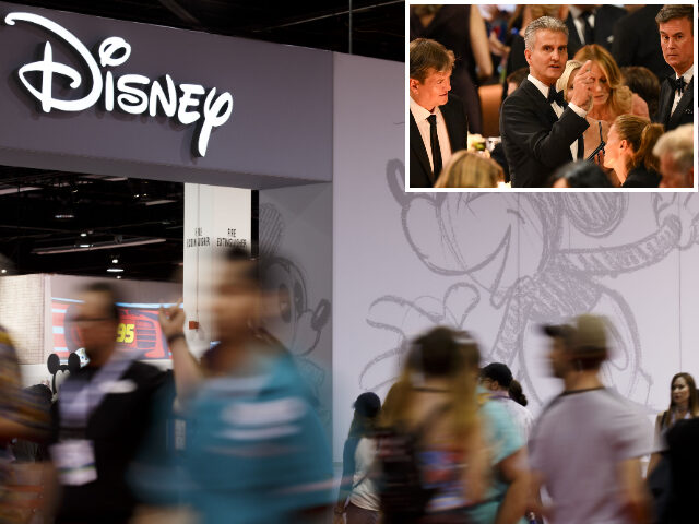 Attendees walk past the Disney Store during the D23 Expo 2017 in Anaheim, California, U.S.