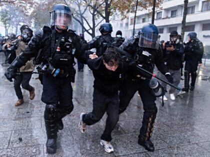 PARIS, FRANCE - OCTOBER 24: Police detain some of the demonstrators as protesters clash wi