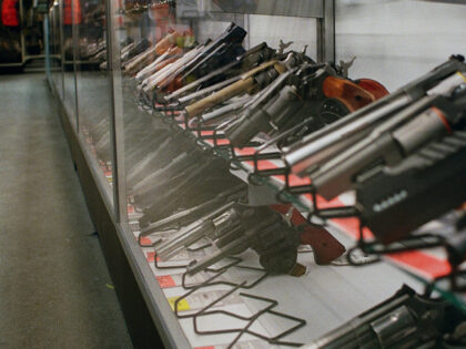 Revolvers displayed in a glass case at a store
