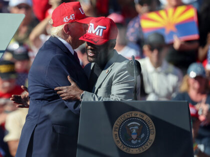 US President Donald Trump and boxer Floyd Mayweather embrace during a campaign event in Bu