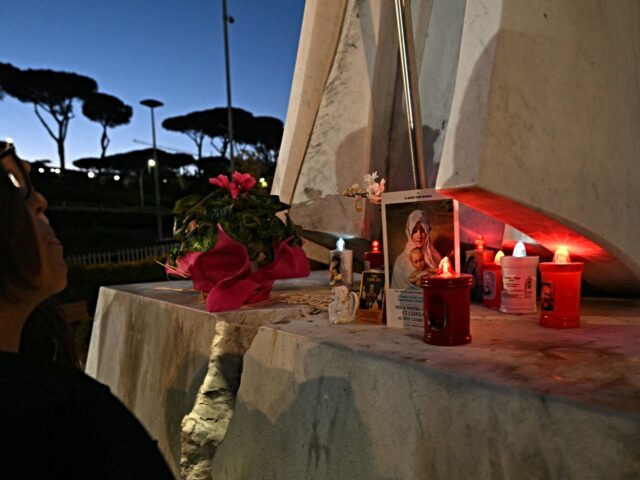 Candles, flowers and prayers are led at the statue of John Paul II outside Rome's Gemelli