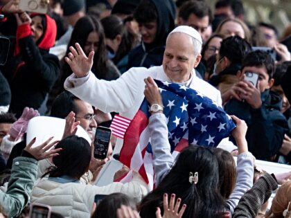 Pope Leo XIV passes in front of a United States flag that waves before his general weekly